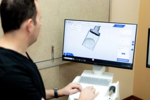 Dr. Smith on a computer working on CEREC dental crowns in Spring, TX