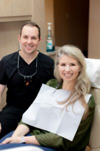Dr. Smith and a dental patient in Spring, TX, smiling at the camera