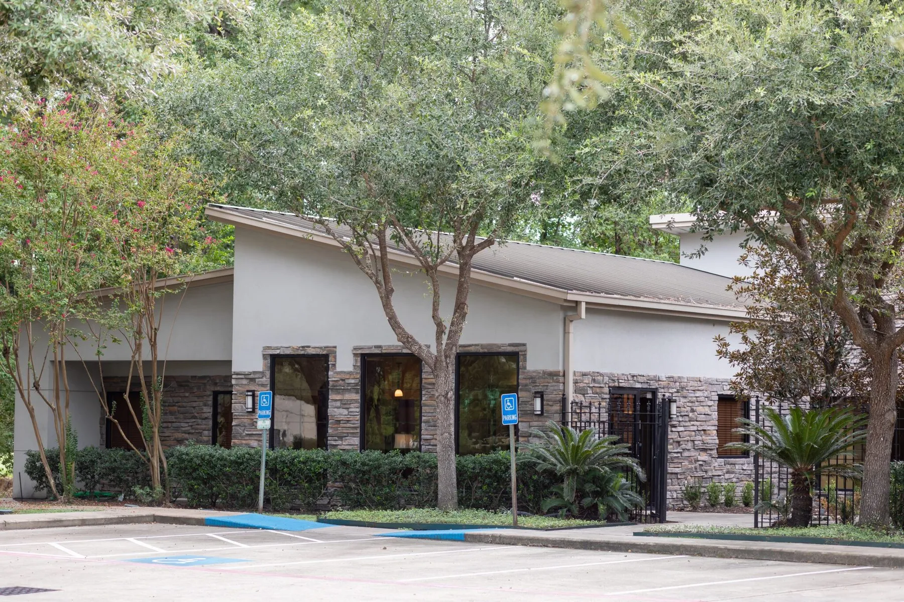 The Oak Hills Dentistry building on Louetta Road in Spring, Texas, shaded by mature trees