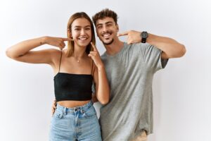 two young people showing off their confident smiles, cosmetic dentistry