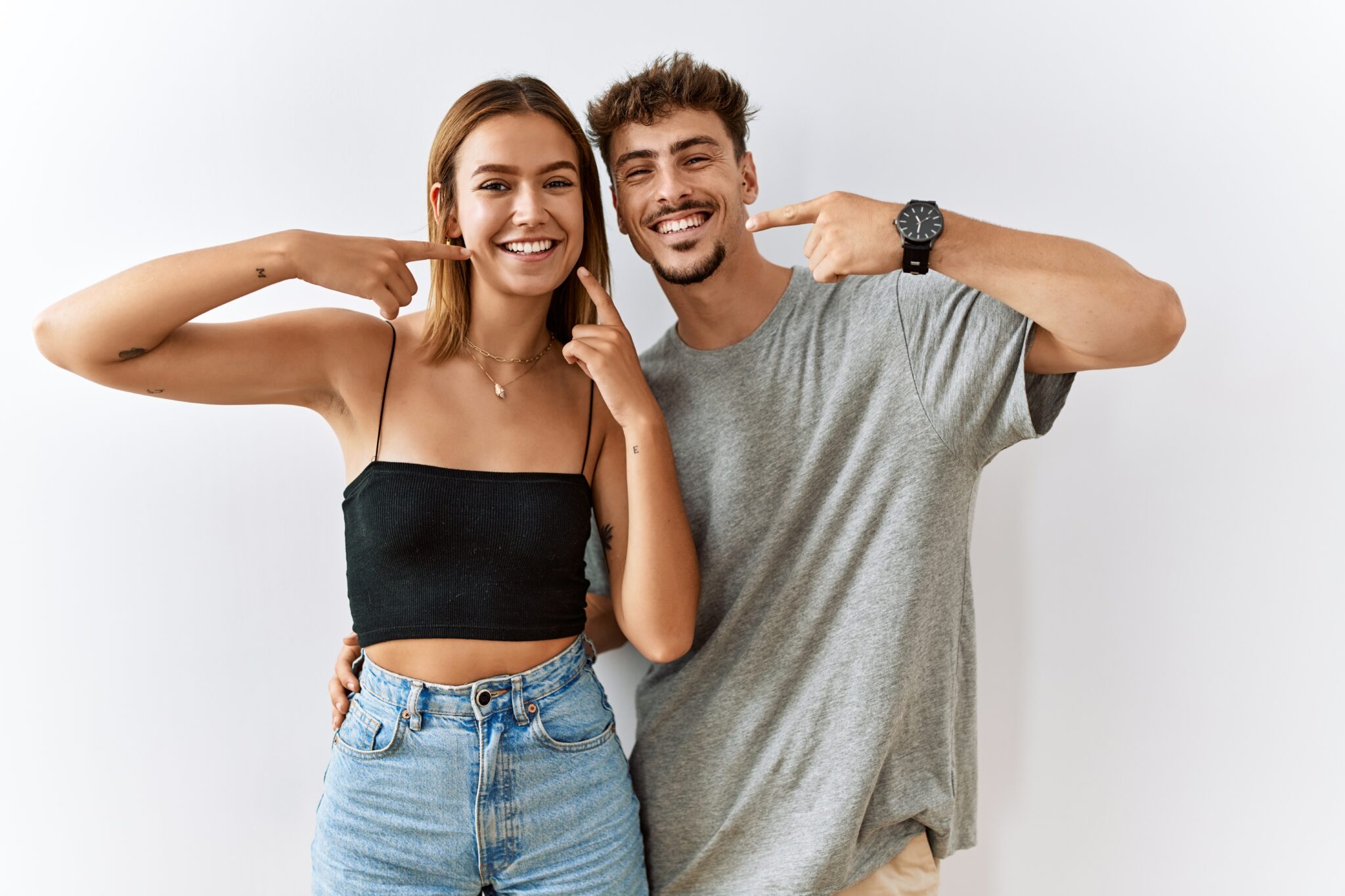 two young people showing off their confident smiles, cosmetic dentistry