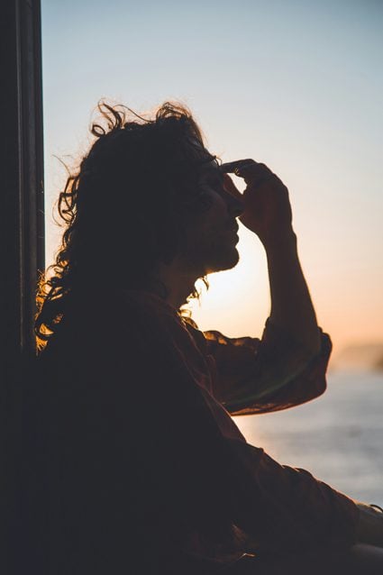 Silouette of a woman holding her head with a TMJ headache in Spring, TX