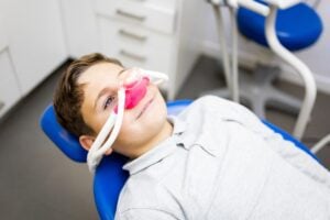 young boy relaxing in a dental chair, conscious sedation