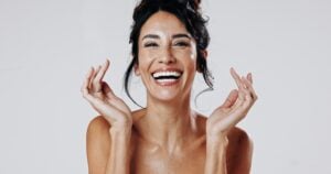 laughing woman showing her new veneers